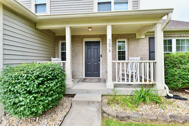 3675 Homestead Cir E, Plainfield, IN 46168 - doorway to property featuring covered porch and brick siding