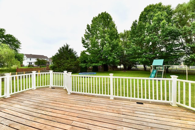 3675 Homestead Cir E, Plainfield, IN 46168 - wooden terrace featuring a trampoline, a playground, and a fenced backyard