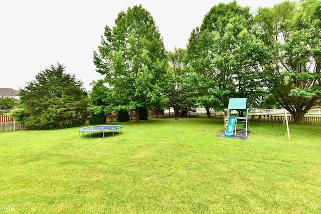 3675 Homestead Cir E, Plainfield, IN 46168 - fenced backyard with a trampoline and a playground
