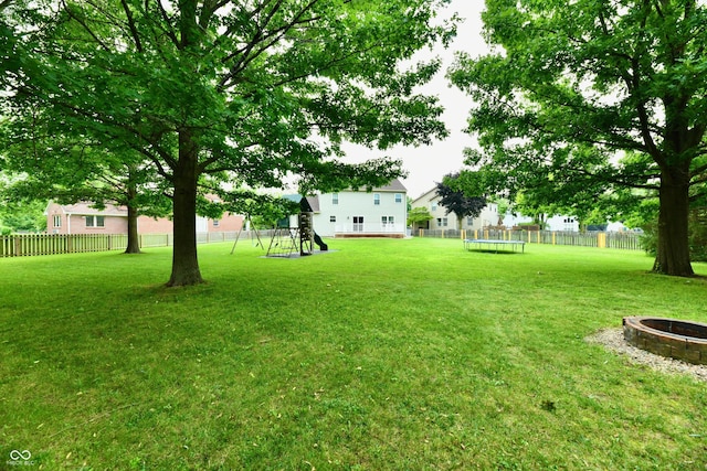 3675 Homestead Cir E, Plainfield, IN 46168 - view of yard featuring a playground, a fire pit, and a trampoline