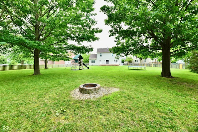 3675 Homestead Cir E, Plainfield, IN 46168 - view of yard featuring a playground, a fire pit, and a trampoline