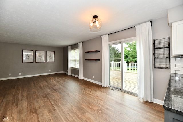 3675 Homestead Cir E, Plainfield, IN 46168 - unfurnished living room with wood finished floors and plenty of natural light