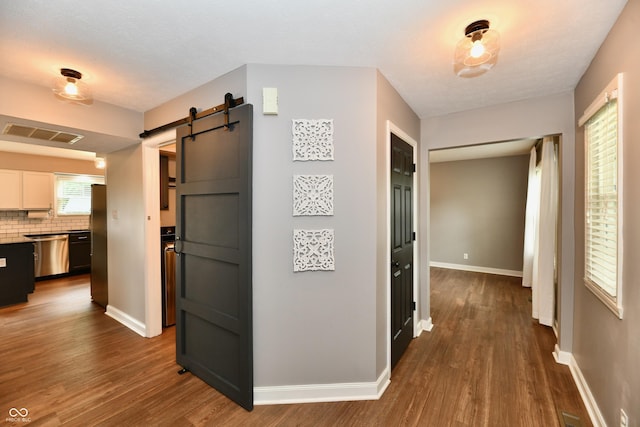 3675 Homestead Cir E, Plainfield, IN 46168 - hallway featuring a barn door and dark wood finished floors
