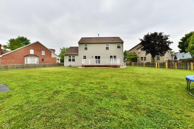 3675 Homestead Cir E, Plainfield, IN 46168 - back of property with a trampoline, a fenced backyard, and a wooden deck