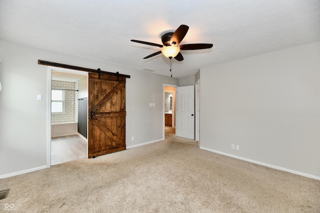 3675 Homestead Cir E, Plainfield, IN 46168 - unfurnished bedroom with a barn door, carpet flooring, connected bathroom, and a ceiling fan