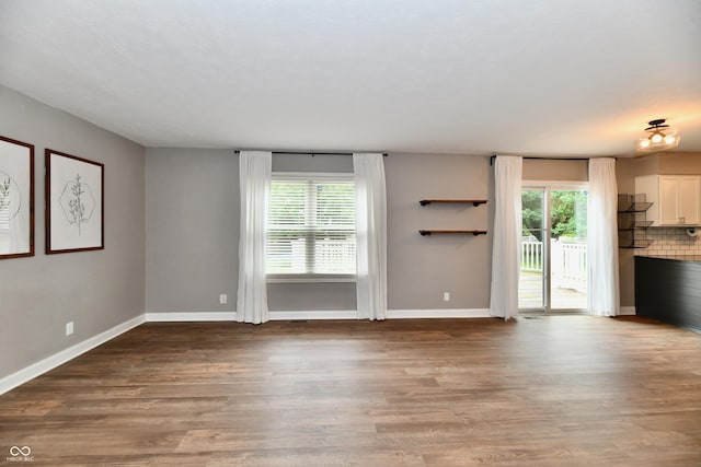 3675 Homestead Cir E, Plainfield, IN 46168 - unfurnished living room featuring wood finished floors and baseboards