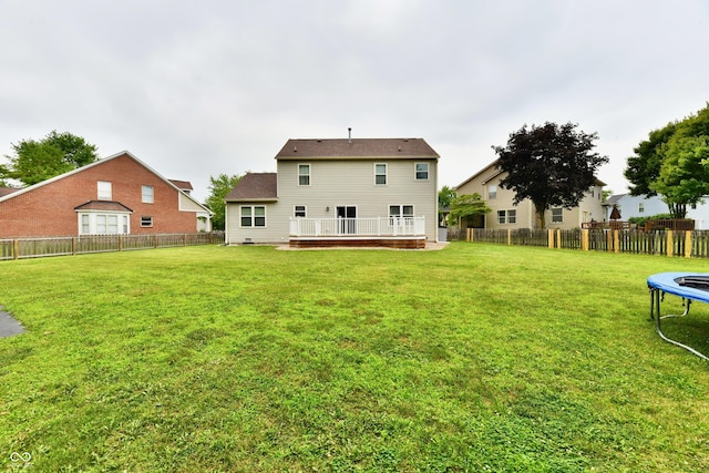 3675 Homestead Cir E, Plainfield, IN 46168 - back of house featuring a trampoline, a fenced backyard, and a deck