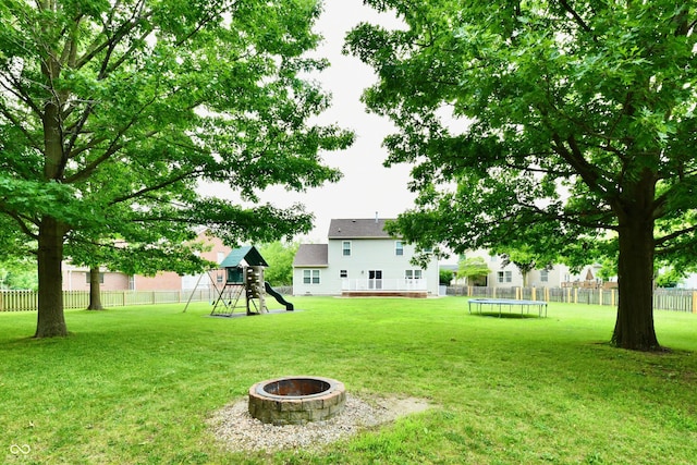 3675 Homestead Cir E, Plainfield, IN 46168 - view of yard featuring a trampoline, a playground, a fire pit, and a deck