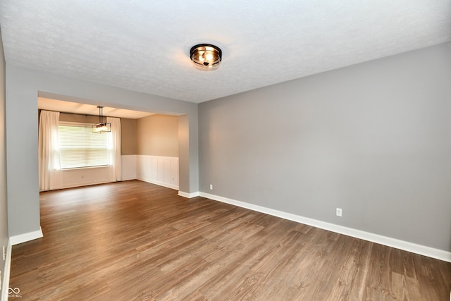 3675 Homestead Cir E, Plainfield, IN 46168 - unfurnished room with wood finished floors, wainscoting, and a textured ceiling
