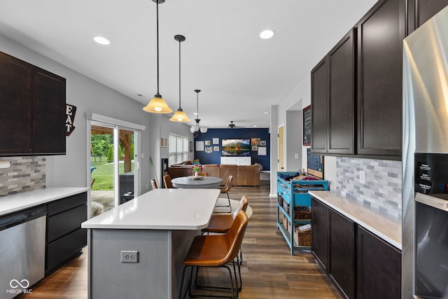 1425 Turkington Ct, Greenwood, IN 46143 - kitchen featuring appliances with stainless steel finishes, dark wood-style floors, light countertops, backsplash, and recessed lighting