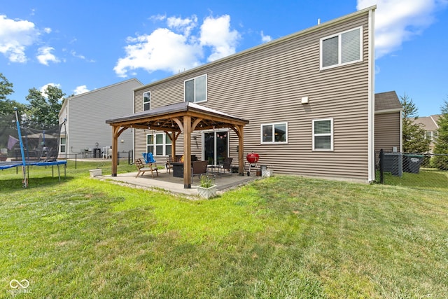 1425 Turkington Ct, Greenwood, IN 46143 - rear view of house featuring a trampoline, a gazebo, a fenced backyard, and a patio