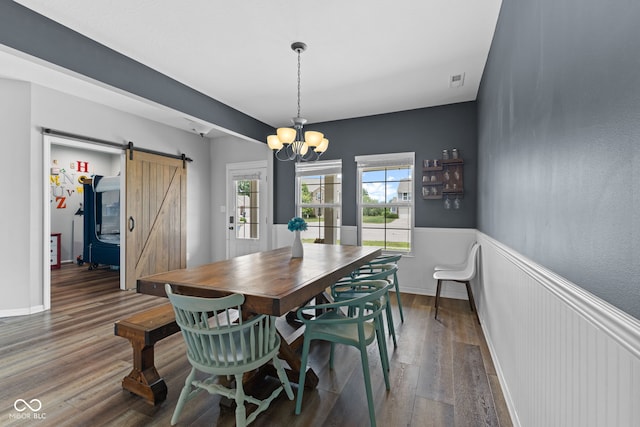1425 Turkington Ct, Greenwood, IN 46143 - dining area with a barn door, dark wood-type flooring, a wainscoted wall, and a chandelier