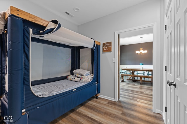 1425 Turkington Ct, Greenwood, IN 46143 - bedroom with wood finished floors and a chandelier