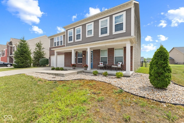 1425 Turkington Ct, Greenwood, IN 46143 - view of front of property with concrete driveway, an attached garage, covered porch, a front yard, and brick siding