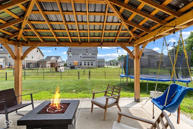 1425 Turkington Ct, Greenwood, IN 46143 - fenced backyard featuring a trampoline, a fire pit, a patio, and a residential view