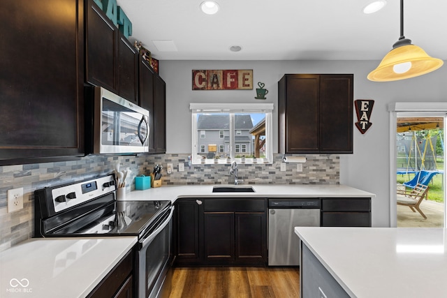 1425 Turkington Ct, Greenwood, IN 46143 - kitchen featuring stainless steel appliances, decorative backsplash, light countertops, recessed lighting, and wood finished floors
