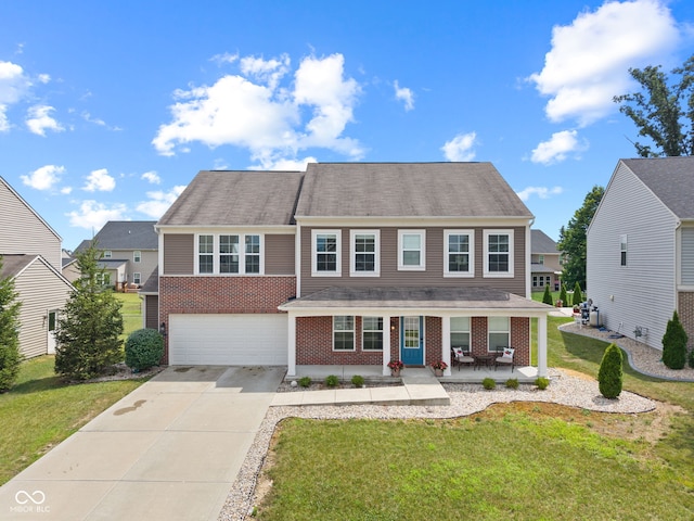 1425 Turkington Ct, Greenwood, IN 46143 - view of front of home featuring driveway, brick siding, a front yard, covered porch, and an attached garage