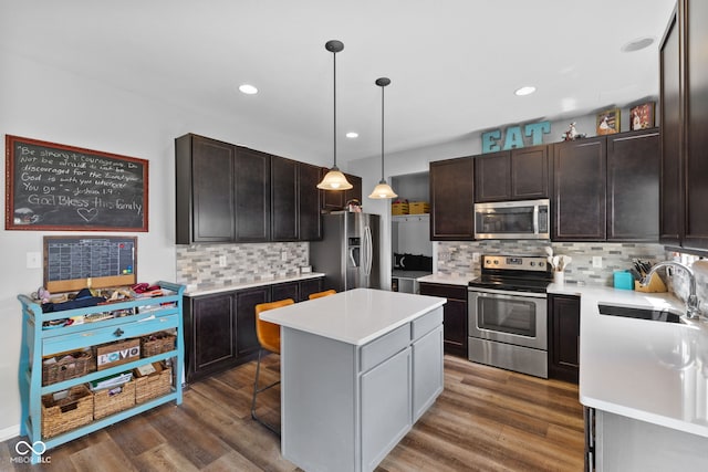 1425 Turkington Ct, Greenwood, IN 46143 - kitchen featuring stainless steel appliances, a center island, tasteful backsplash, light countertops, and recessed lighting