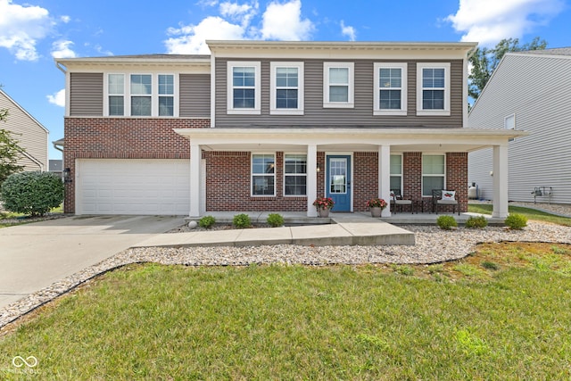 1425 Turkington Ct, Greenwood, IN 46143 - view of front of home with brick siding, an attached garage, driveway, a porch, and a front yard