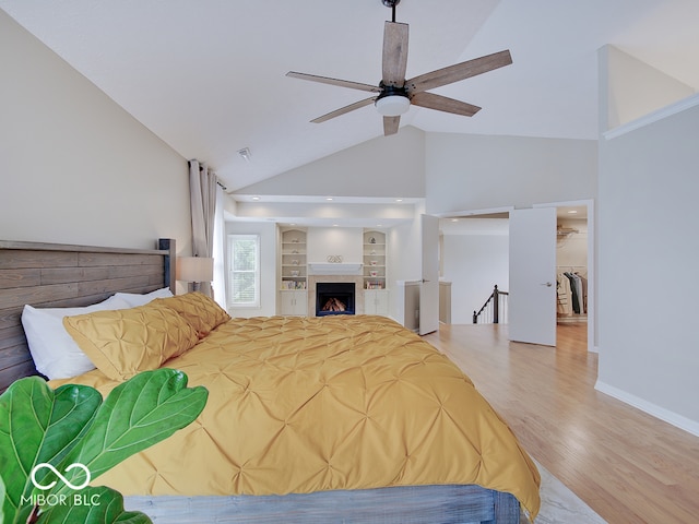 11668 Victoria Ct, Carmel, IN 46033 - bedroom with high vaulted ceiling, wood finished floors, and a fireplace