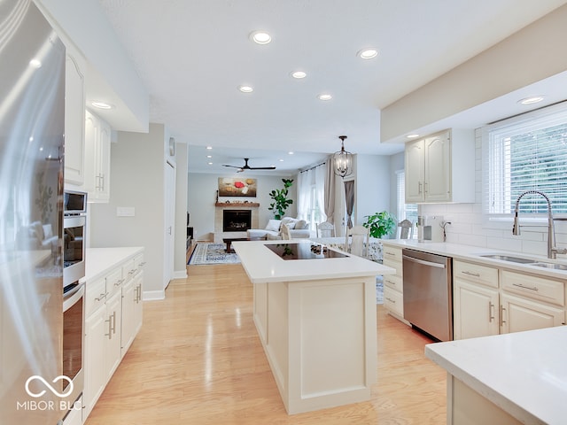 11668 Victoria Ct, Carmel, IN 46033 - kitchen featuring stainless steel dishwasher, recessed lighting, a kitchen island, light wood finished floors, and ceiling fan
