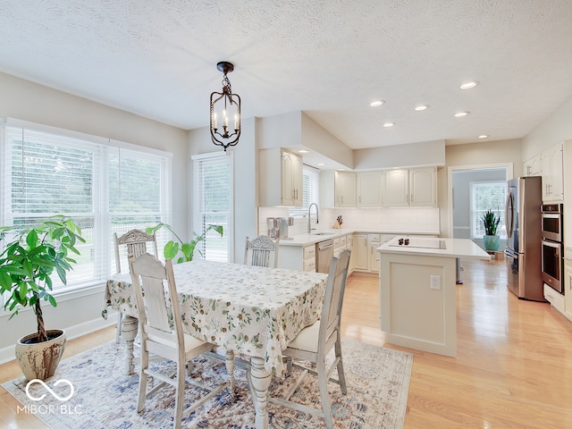 11668 Victoria Ct, Carmel, IN 46033 - dining room with light wood-style floors, recessed lighting, a chandelier, and a textured ceiling