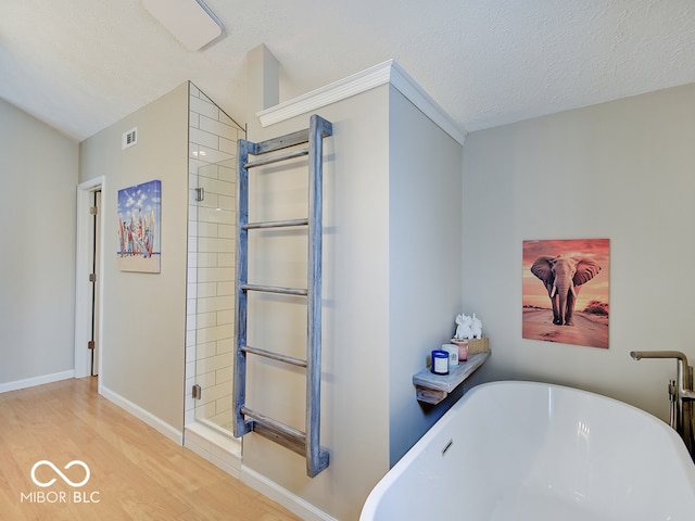 11668 Victoria Ct, Carmel, IN 46033 - bathroom with a freestanding bath, wood finished floors, a textured ceiling, and a shower stall