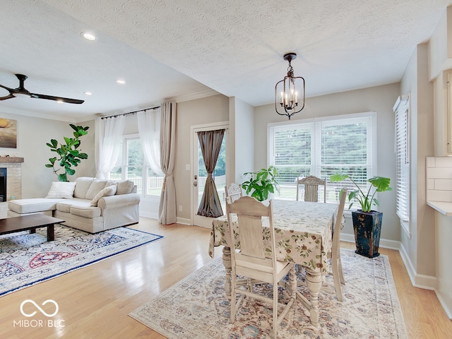 11668 Victoria Ct, Carmel, IN 46033 - dining area with a chandelier, a textured ceiling, light wood-style flooring, ceiling fan, and recessed lighting