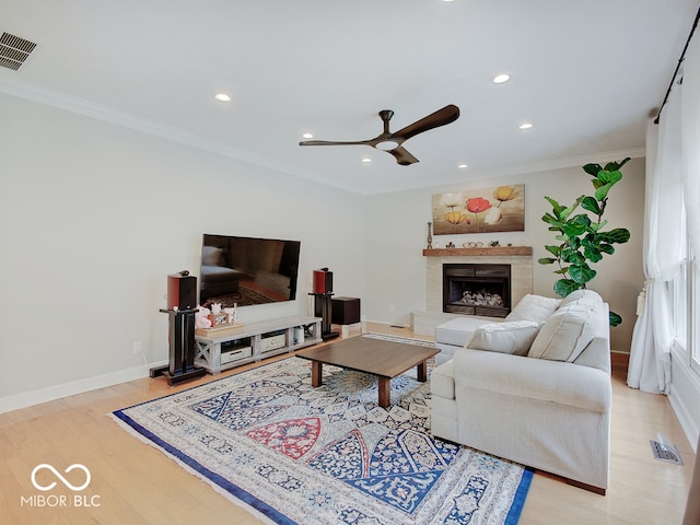 11668 Victoria Ct, Carmel, IN 46033 - living room featuring recessed lighting, light wood finished floors, a ceiling fan, crown molding, and a tile fireplace
