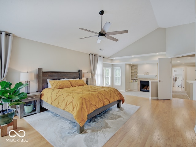 11668 Victoria Ct, Carmel, IN 46033 - bedroom with light wood-style flooring, high vaulted ceiling, a fireplace, and a ceiling fan