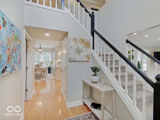 11668 Victoria Ct, Carmel, IN 46033 - staircase with wood finished floors, a towering ceiling, ornamental molding, and recessed lighting
