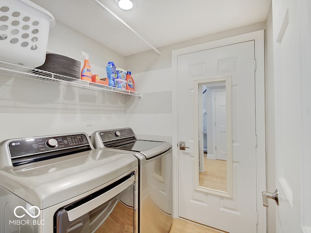11668 Victoria Ct, Carmel, IN 46033 - laundry room with independent washer and dryer and light wood-style floors