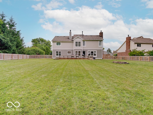 11668 Victoria Ct, Carmel, IN 46033 - rear view of house with a fenced backyard, a deck, stucco siding, and a chimney