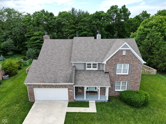 11668 Victoria Ct, Carmel, IN 46033 - view of front of house with a chimney, an attached garage, a front lawn, brick siding, and driveway