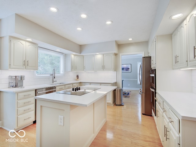 11668 Victoria Ct, Carmel, IN 46033 - kitchen with stainless steel appliances, recessed lighting, a center island, tasteful backsplash, and light wood finished floors