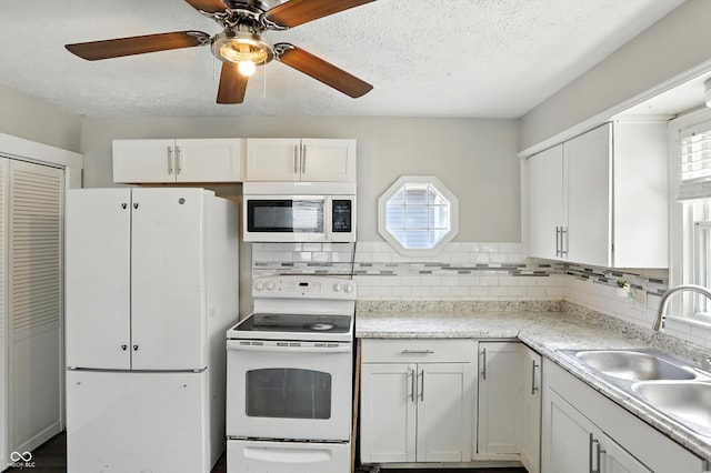 363 N 19th Ave, Beech Grove, IN 46107 - kitchen with white appliances, ceiling fan, white cabinets, tasteful backsplash, and a textured ceiling