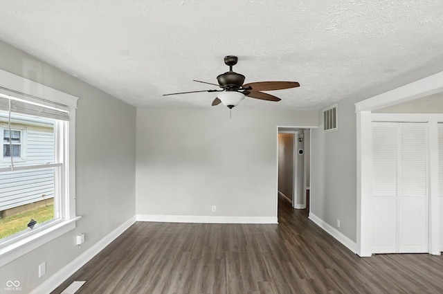 363 N 19th Ave, Beech Grove, IN 46107 - spare room with dark wood finished floors, a ceiling fan, and a textured ceiling