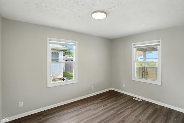 363 N 19th Ave, Beech Grove, IN 46107 - unfurnished room featuring dark wood-type flooring and a textured ceiling