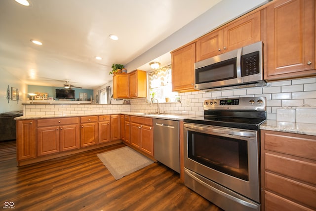 5514 Meckes Ln, Indianapolis, IN 46237 - kitchen featuring stainless steel appliances, a peninsula, open floor plan, tasteful backsplash, and recessed lighting
