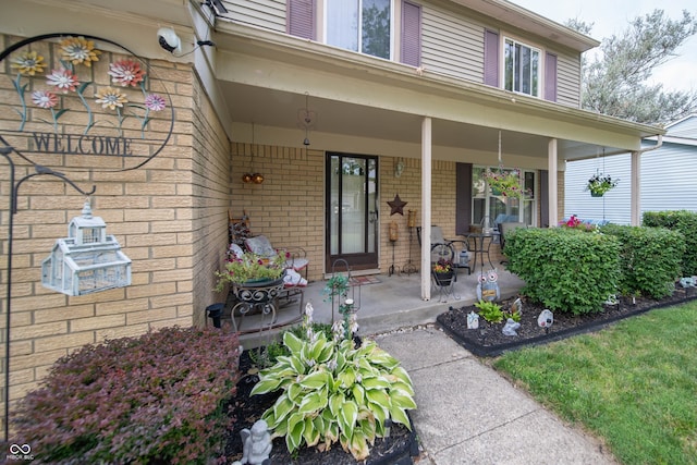 5514 Meckes Ln, Indianapolis, IN 46237 - doorway to property featuring covered porch and brick siding
