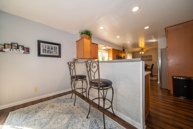 5514 Meckes Ln, Indianapolis, IN 46237 - kitchen featuring appliances with stainless steel finishes, a peninsula, dark wood-style flooring, recessed lighting, and ceiling fan