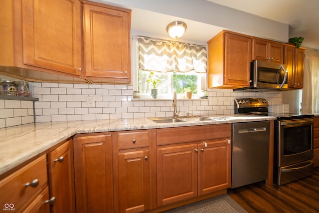 5514 Meckes Ln, Indianapolis, IN 46237 - kitchen featuring stainless steel appliances, tasteful backsplash, dark wood-style flooring, and brown cabinets