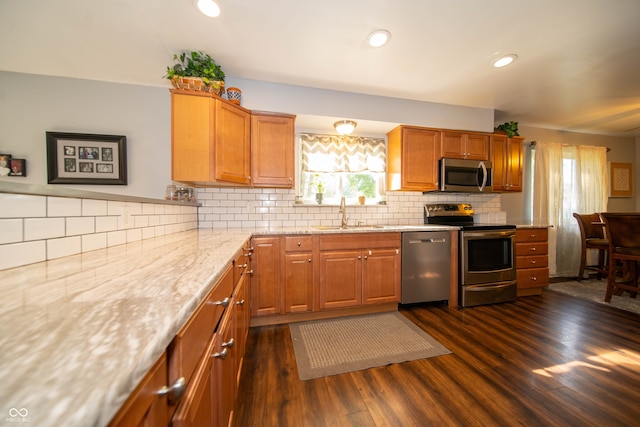5514 Meckes Ln, Indianapolis, IN 46237 - kitchen featuring appliances with stainless steel finishes, dark wood-style flooring, healthy amount of natural light, tasteful backsplash, and recessed lighting