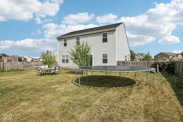2302 Ashton Ln, Greenwood, IN 46143 - rear view of property featuring a trampoline, a fenced backyard, and a residential view