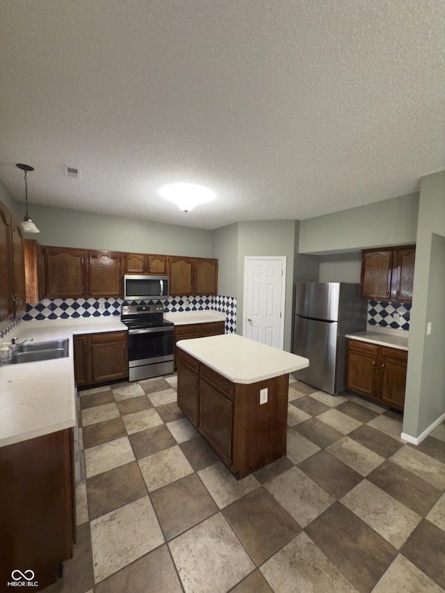 1881 Harvest Meadow Dr, Greenwood, IN 46143 - kitchen with stainless steel appliances, decorative backsplash, a kitchen island, light countertops, and a textured ceiling
