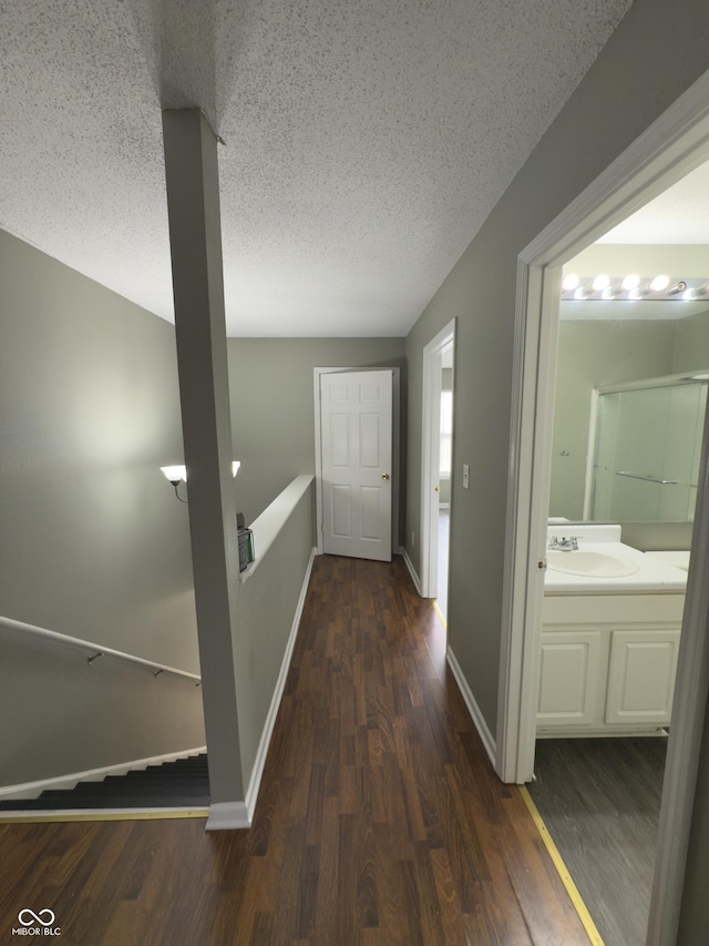 1881 Harvest Meadow Dr, Greenwood, IN 46143 - corridor with a textured ceiling, wood finished floors, and an upstairs landing