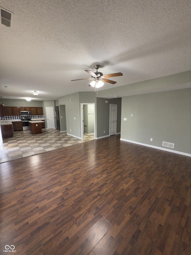1881 Harvest Meadow Dr, Greenwood, IN 46143 - unfurnished living room with ceiling fan, wood finished floors, and a textured ceiling