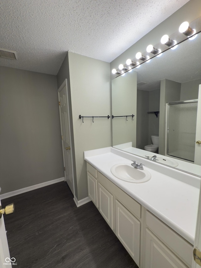 1881 Harvest Meadow Dr, Greenwood, IN 46143 - bathroom with wood finished floors, vanity, a stall shower, and a textured ceiling