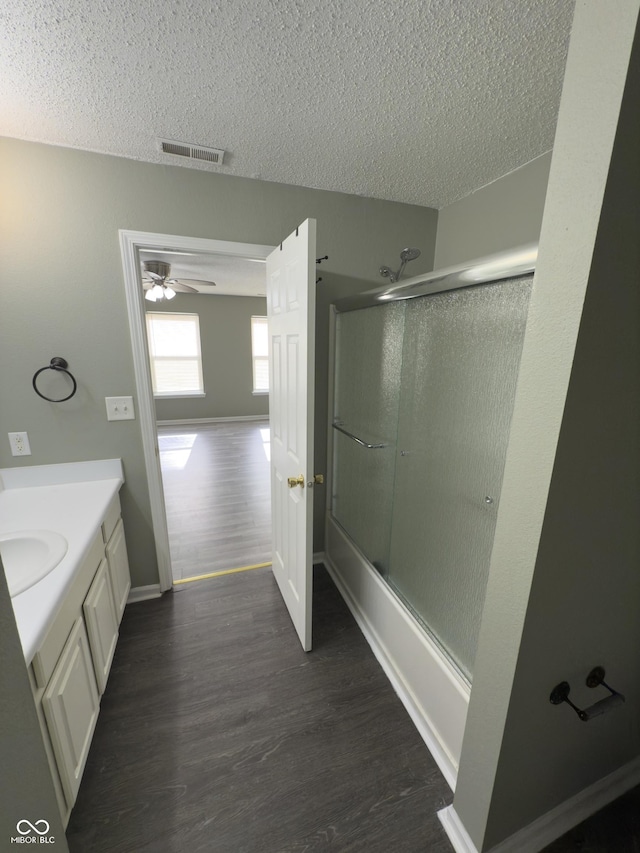 1881 Harvest Meadow Dr, Greenwood, IN 46143 - bathroom with wood finished floors, a textured ceiling, enclosed tub / shower combo, vanity, and ceiling fan