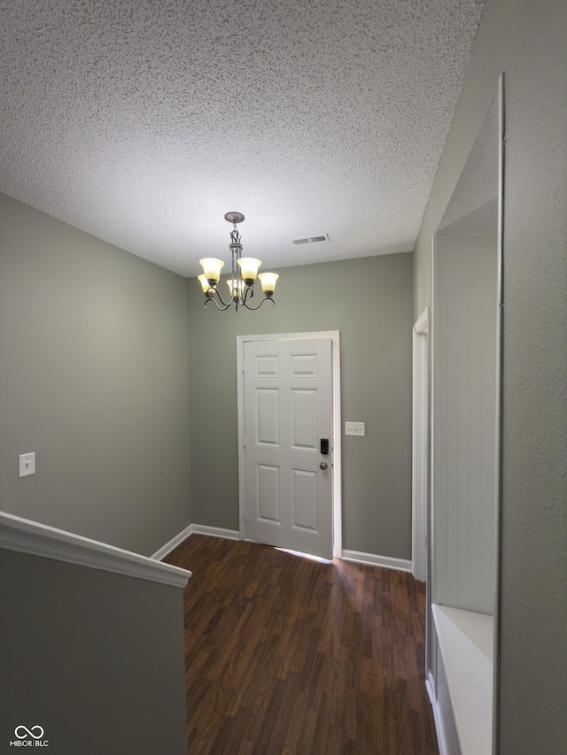 1881 Harvest Meadow Dr, Greenwood, IN 46143 - entrance foyer featuring a chandelier, dark wood-style flooring, and a textured ceiling